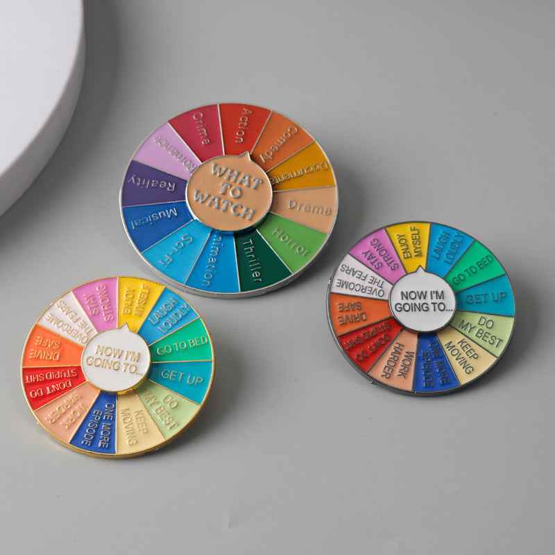Circular spinner brooches with colorful segments and gold center text, 3-pack set