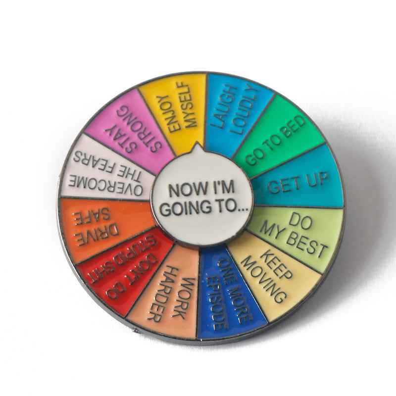 Circular spinner brooch wheel with 'NOW I'M GOING TO…' center and colorful action wedges