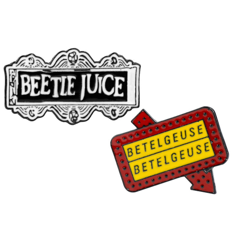 Set of two alloy enamel-style brooches: “BEETLE JUICE” and “BETELGEUSE” signs