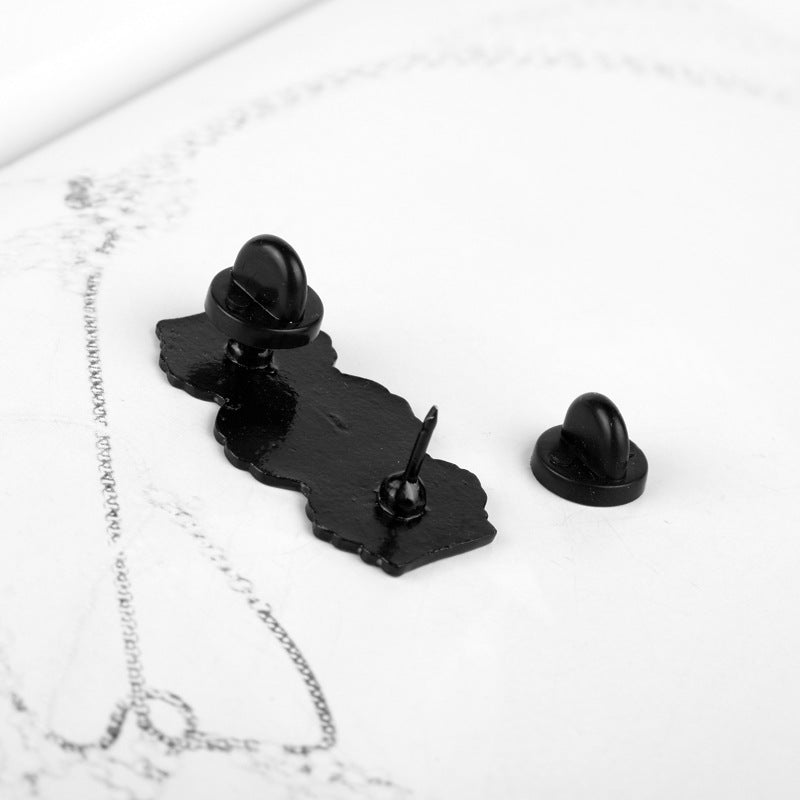 Black alloy brooch with dome-style pin back and two mounting posts