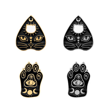 Cat claw witch brooches, gold and dark triangular designs with sun and eye motifs