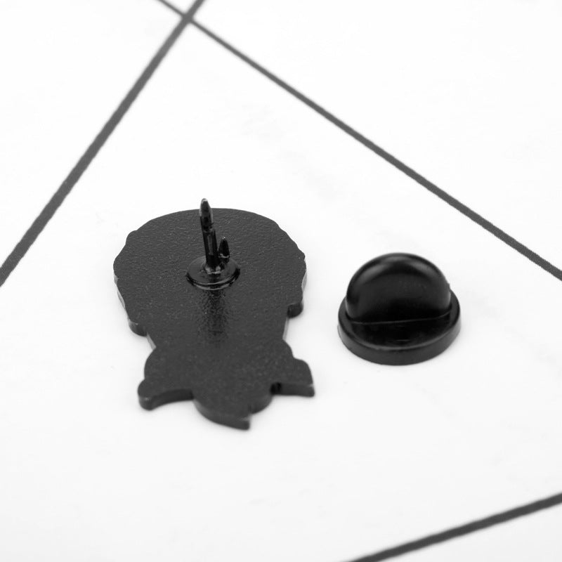 Enamel lapel pin backing: black metal clasp and pin post on display backing card.