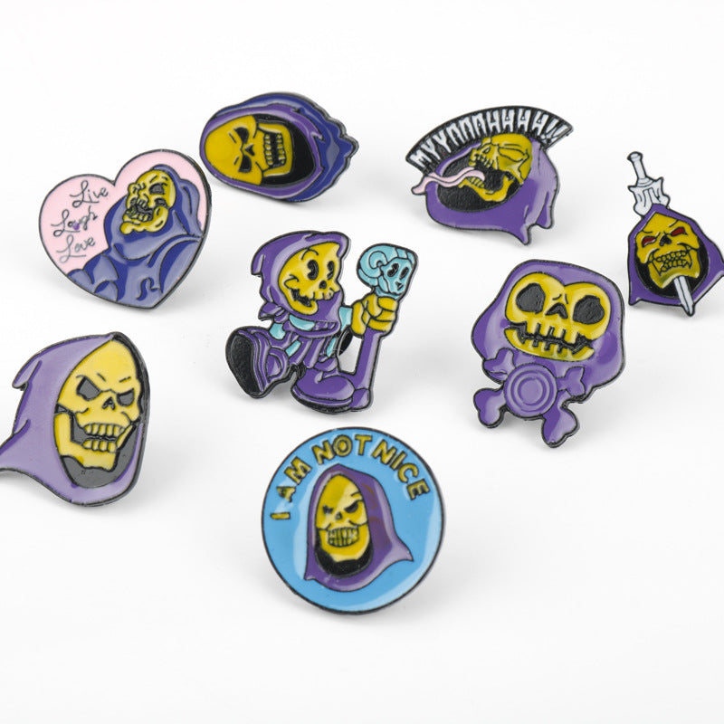 Assorted Skull King turban Halloween brooch pins, purple enamel skull motifs