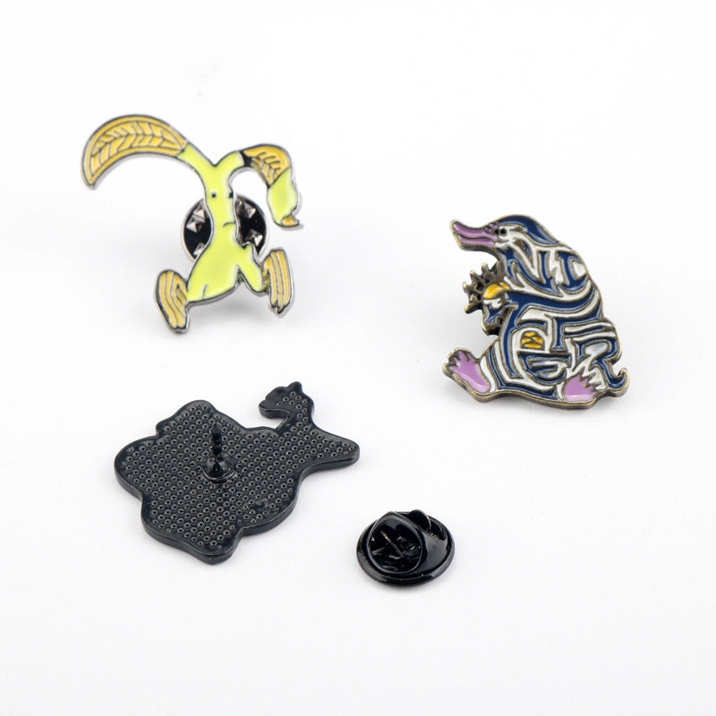 3-pack Niffler metal brooch pins with colorful fronts and black pin backs visible