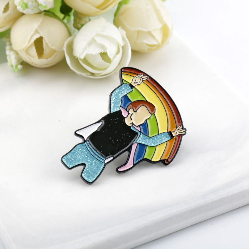 Rainbow bridge metal brooch with a person hugging a rainbow, glittery glitter coat