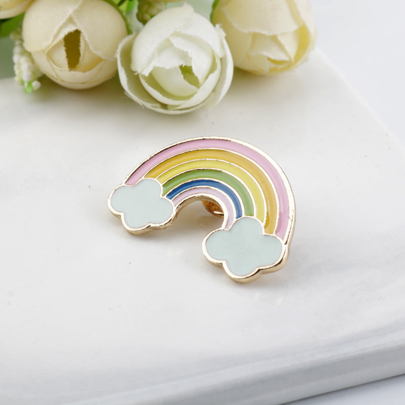 Rainbow bridge metal brooch with pale clouds and pastel rainbow stripes, arched shape