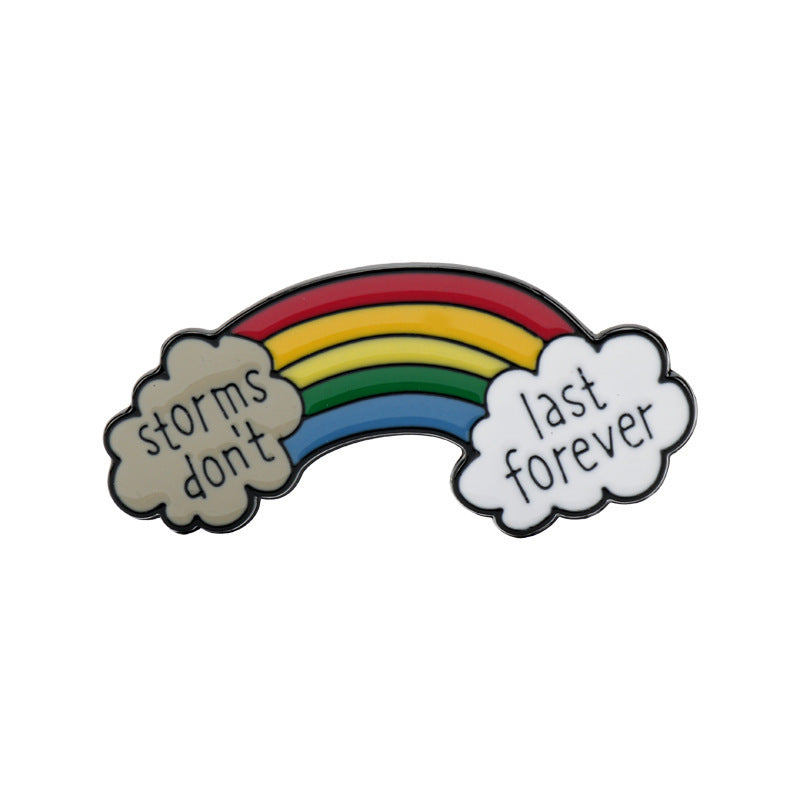 Rainbow bridge metal brooch with “storms don’t last” and “last forever” on clouds