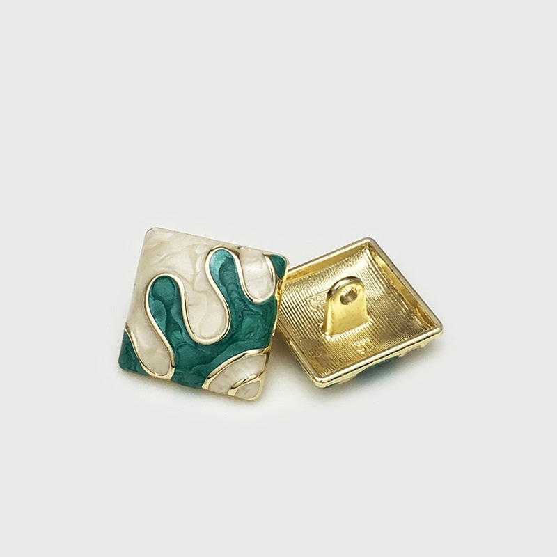 Cloisonné metal button with loop, teardrop teal enamel accents on off-white base, gold tone