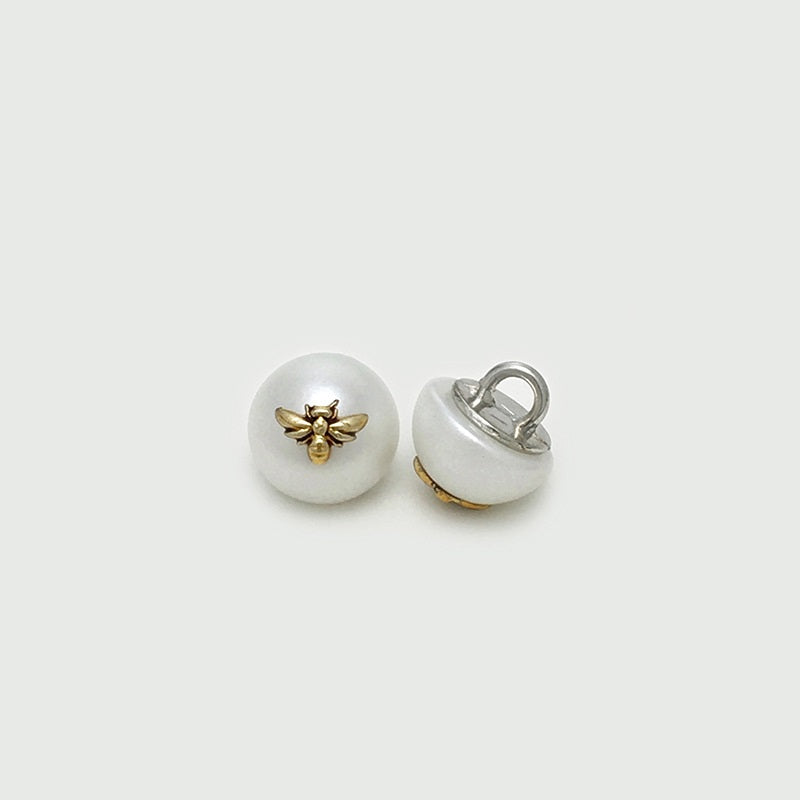 White pearl bee buttons showing loop attachment, front and back