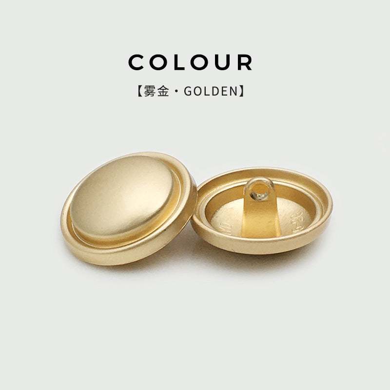 Matte gold round mushroom metal buttons, slim curved edge, front view
