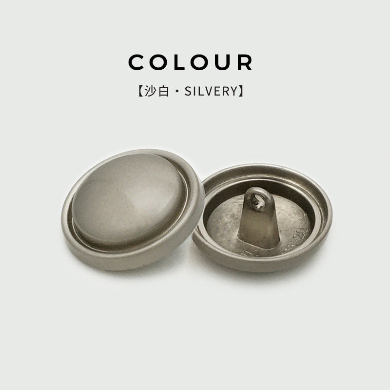 Matte silver round mushroom metal buttons, slim curved edge, front view