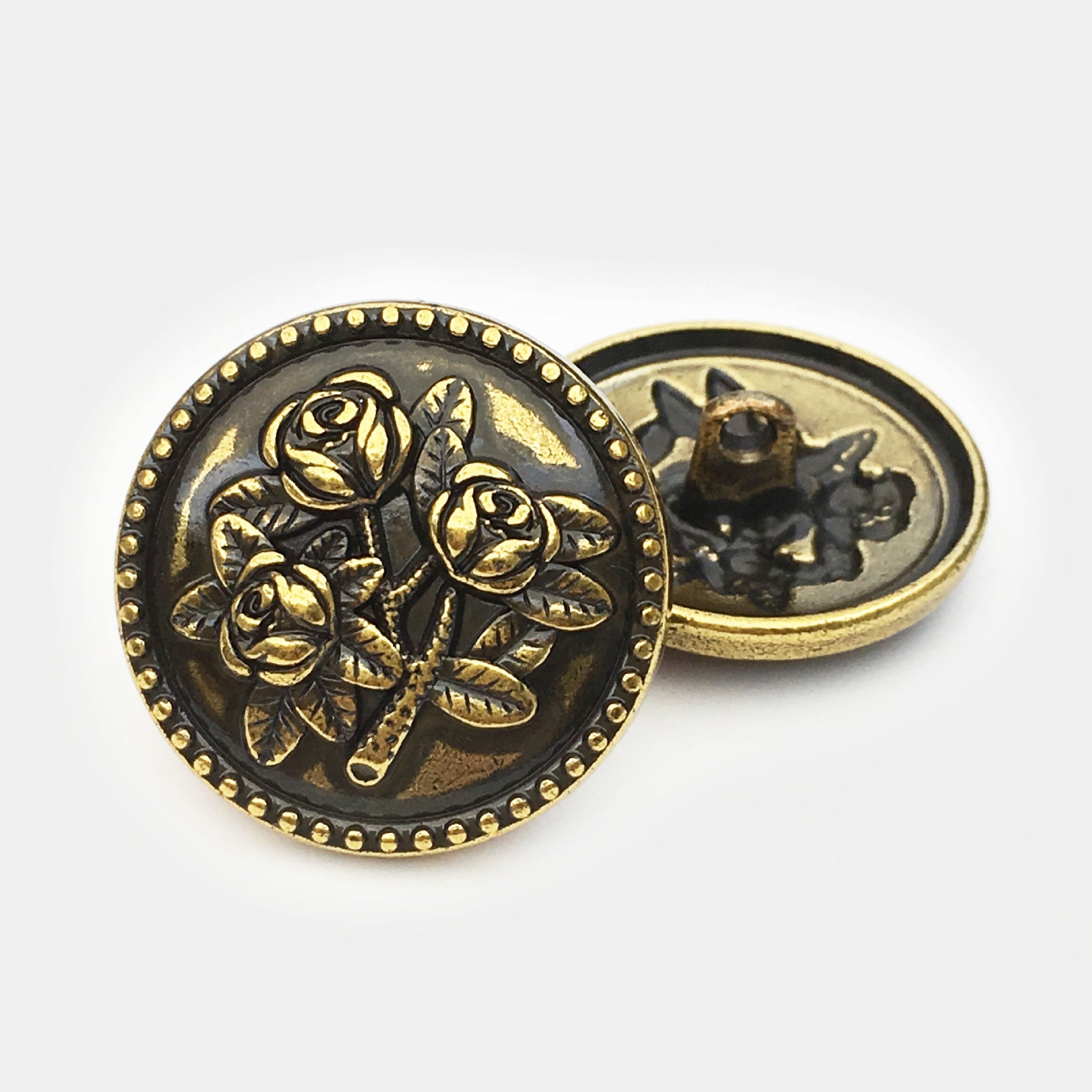 Round rose metal button, gold engraved roses on black bronze; shows front and back