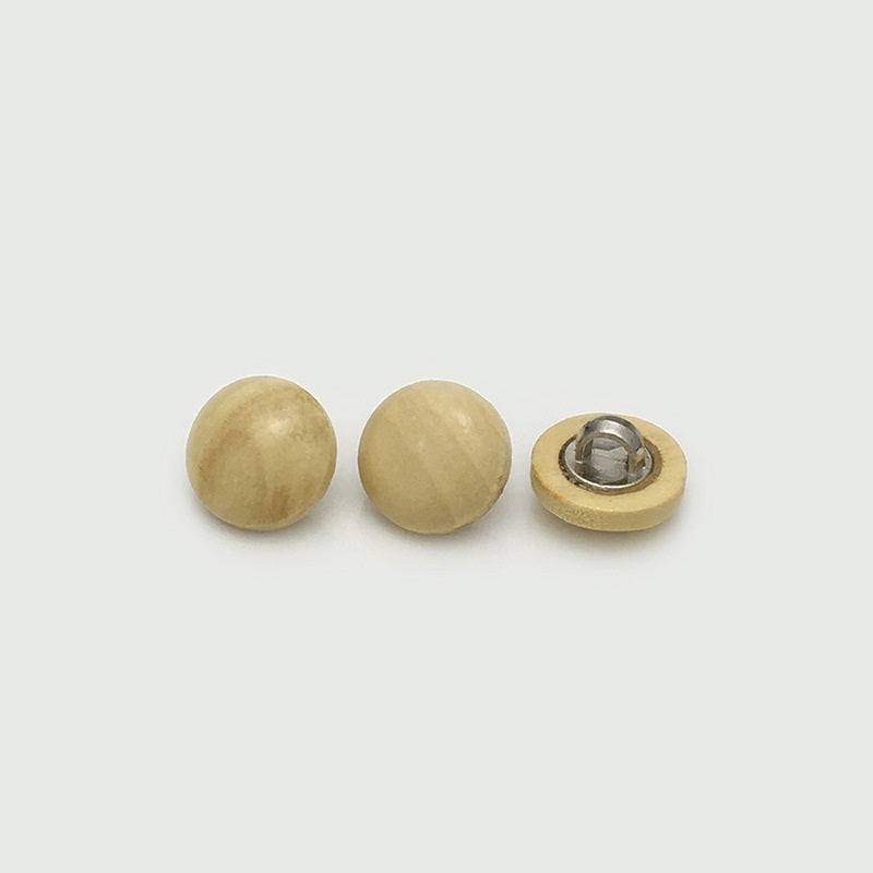 Wooden mushroom buttons in light yellow/cream tone with visible metal shank