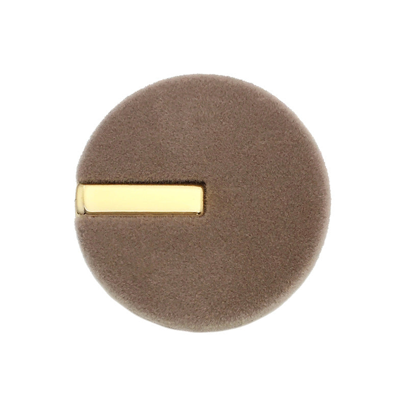 Brown round velvet button with gold metal bar front