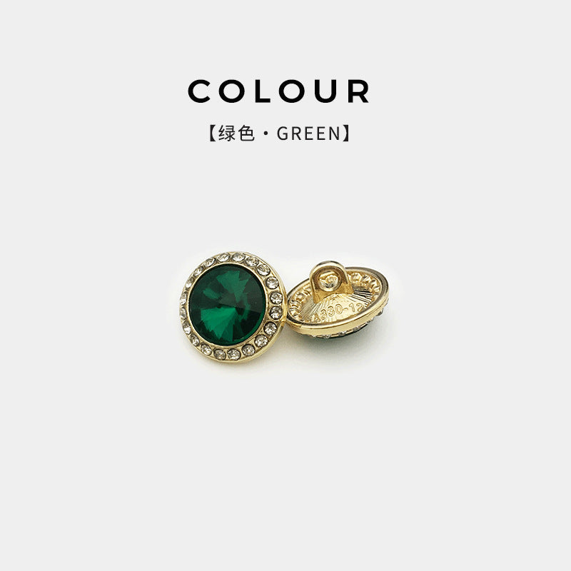 Gold button with emerald-green glass diamond and rhinestone border, shirt accessory