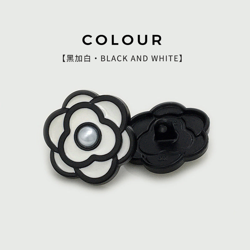 Camellia pearl button, black outline with white petals and round pearl center