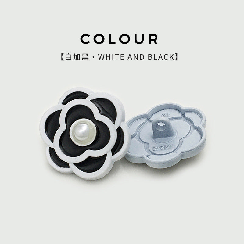 Camellia pearl button, white outline with black petals and round pearl center