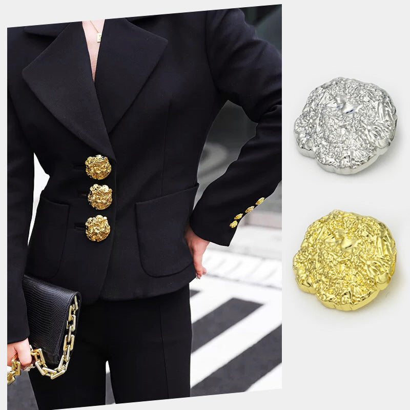 Irregular pleated metal shank buttons on jacket front; gold and silver set