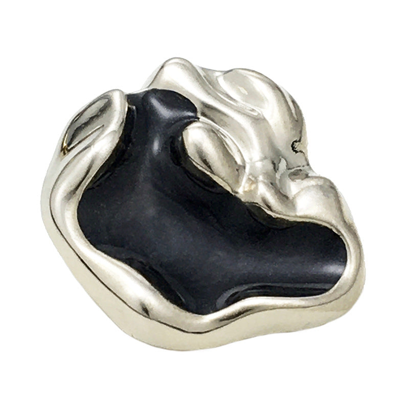 Irregular metal button with silver rim and black insert
