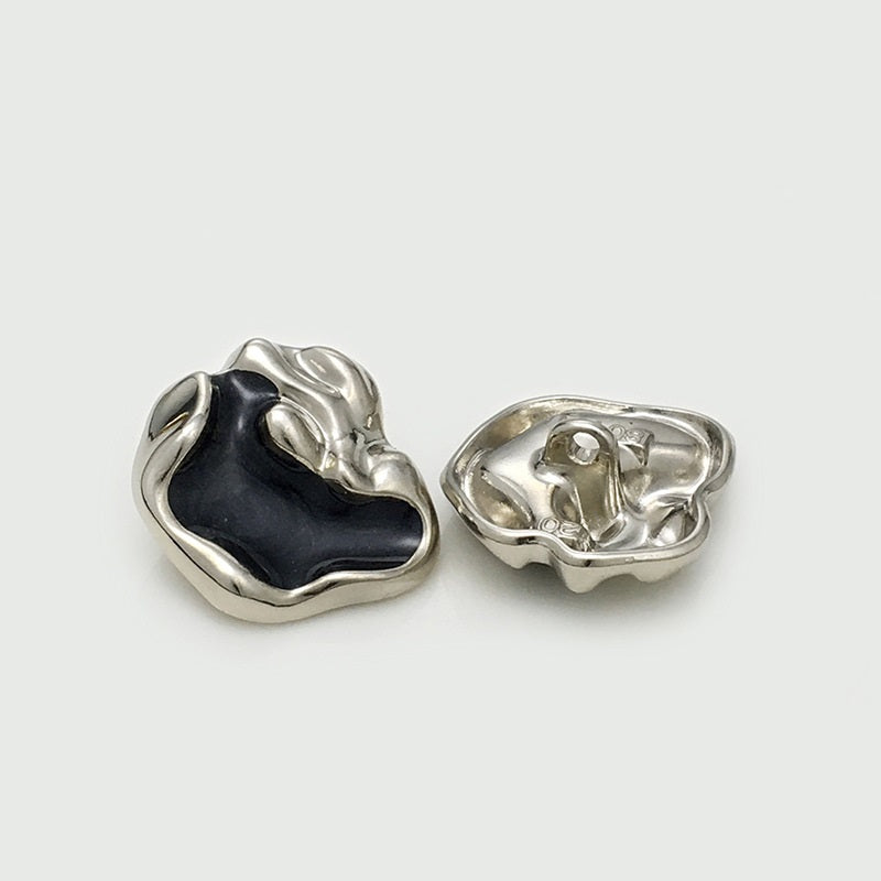 Irregular metal button with black insert: front and back views