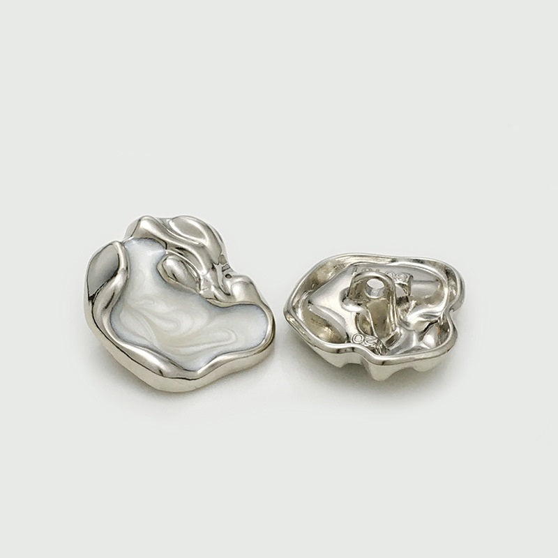 Irregular silver metal button: front and back with loop shank