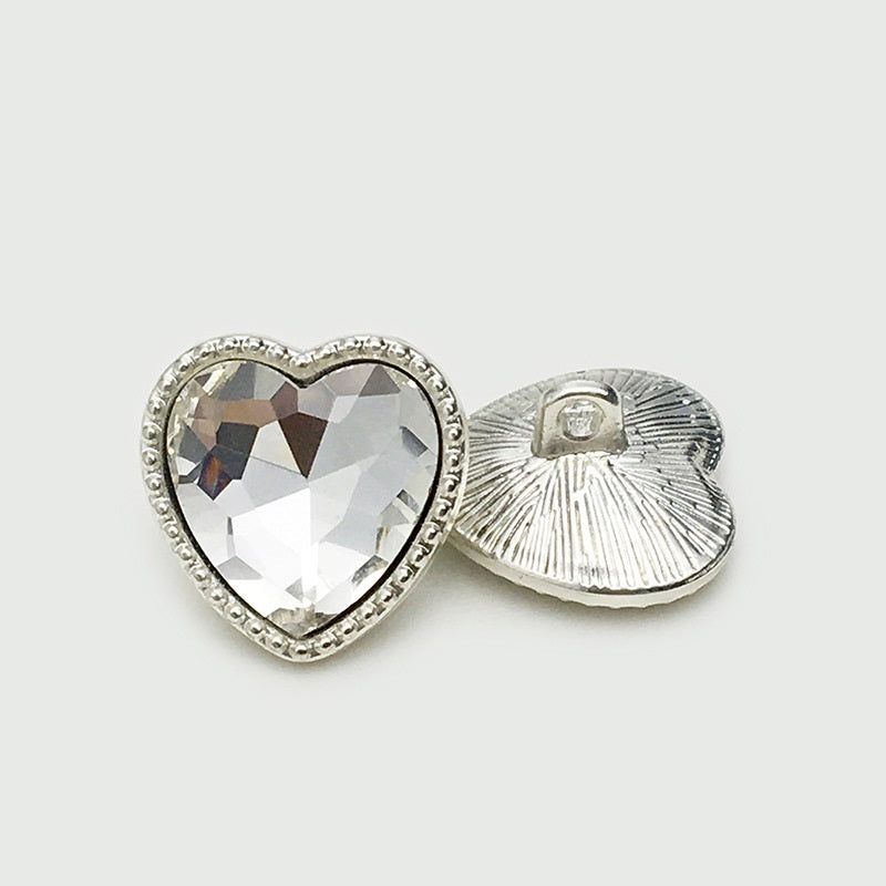 Heart-shaped diamond-look metal button with rhinestone rim and visible sewing back