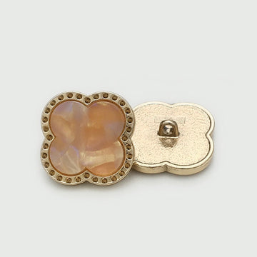 Pink-gold metal button with heart/flower design, jewel-look center and shank back