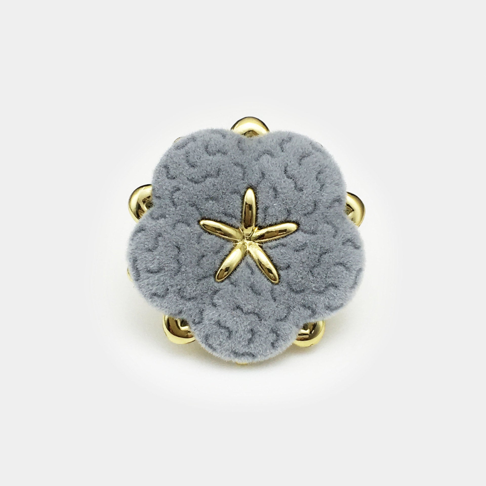 Velvet floral button, light blue-gray with gold star center and four metal shanks