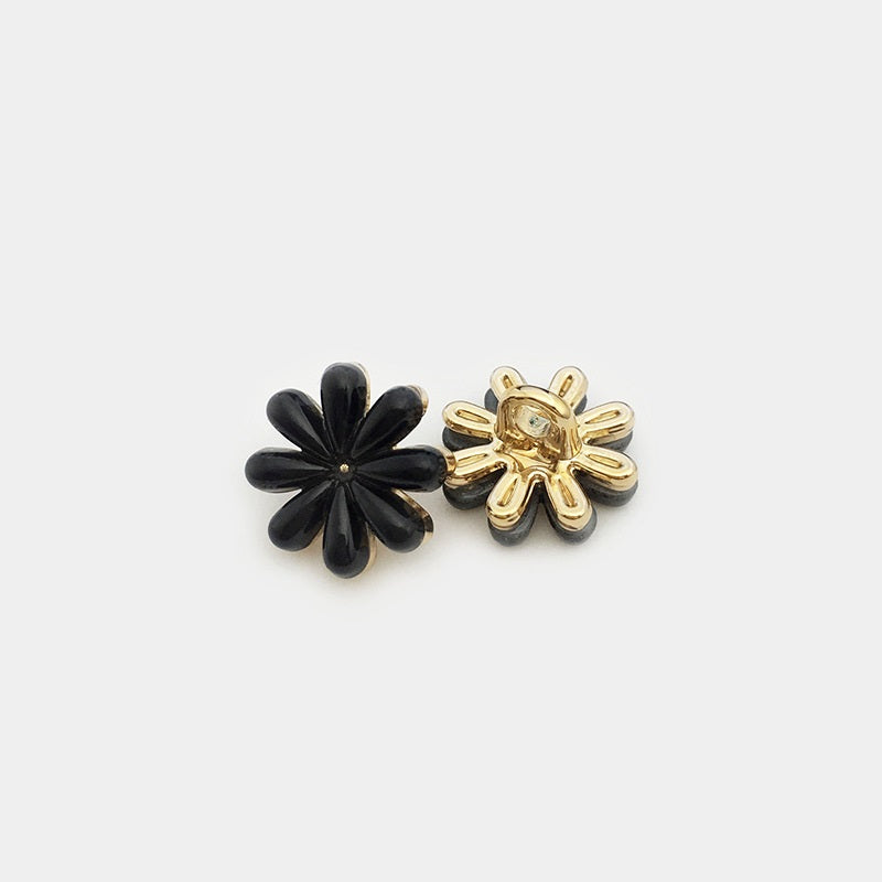 Black daisy flower metal button with gold-tone back and clear center