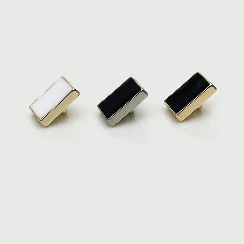 Rectangular metal shirt buttons with white and black fronts, assorted finishes