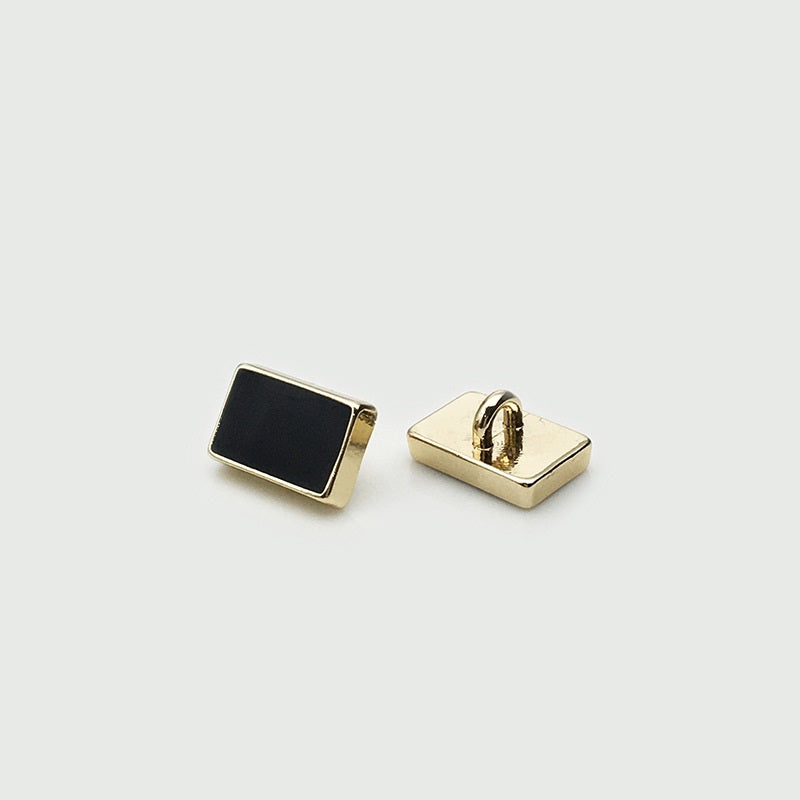 Rectangular shirt sewing button: black front with gold-tone back and shank