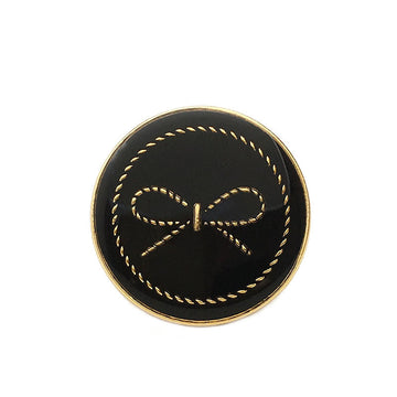 Black round button with bow motif, gold-tone rim and stitched bow detail