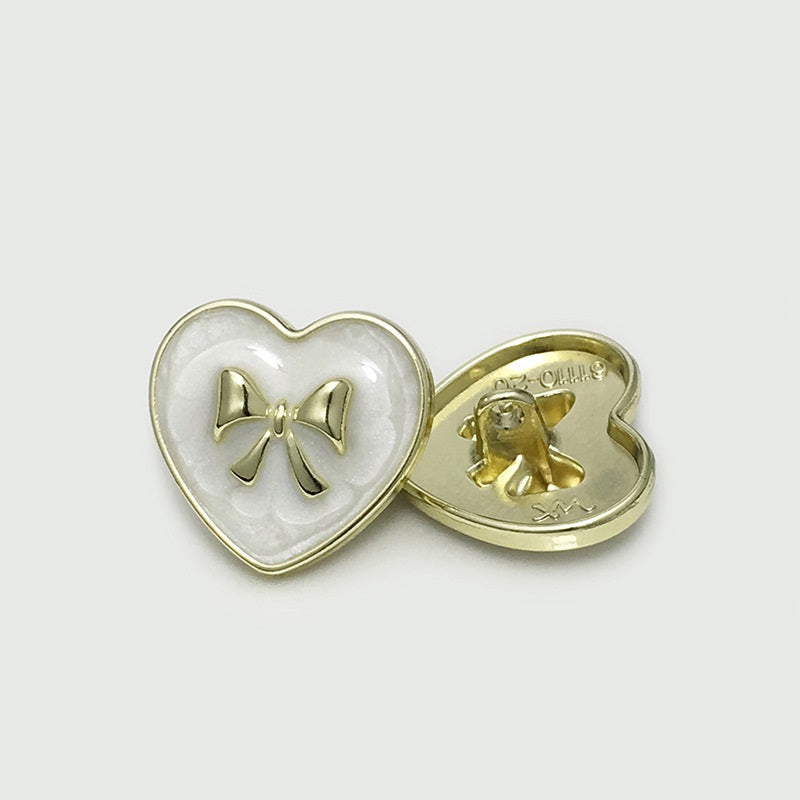 White heart bow metal button with gold-tone bow, shown side with back