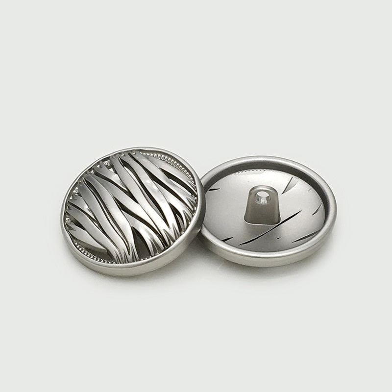 Silver hollow metal button, irregular round front with ridges; back shows metal shank