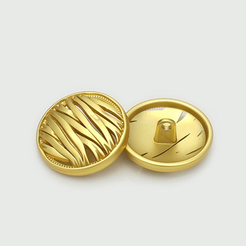 Gold hollow metal button, irregular round front with ridges; back shows metal shank