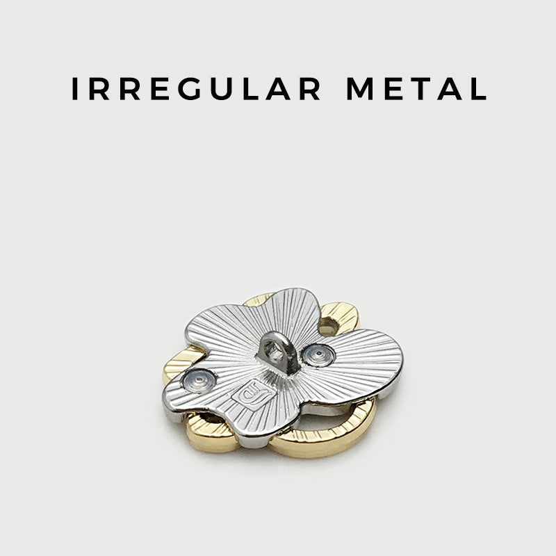 Irregular metal button, silver petal-like face with gold accents, shank