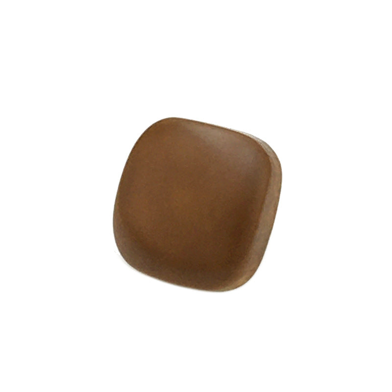 Brown square wood button with metal shank, front close-up