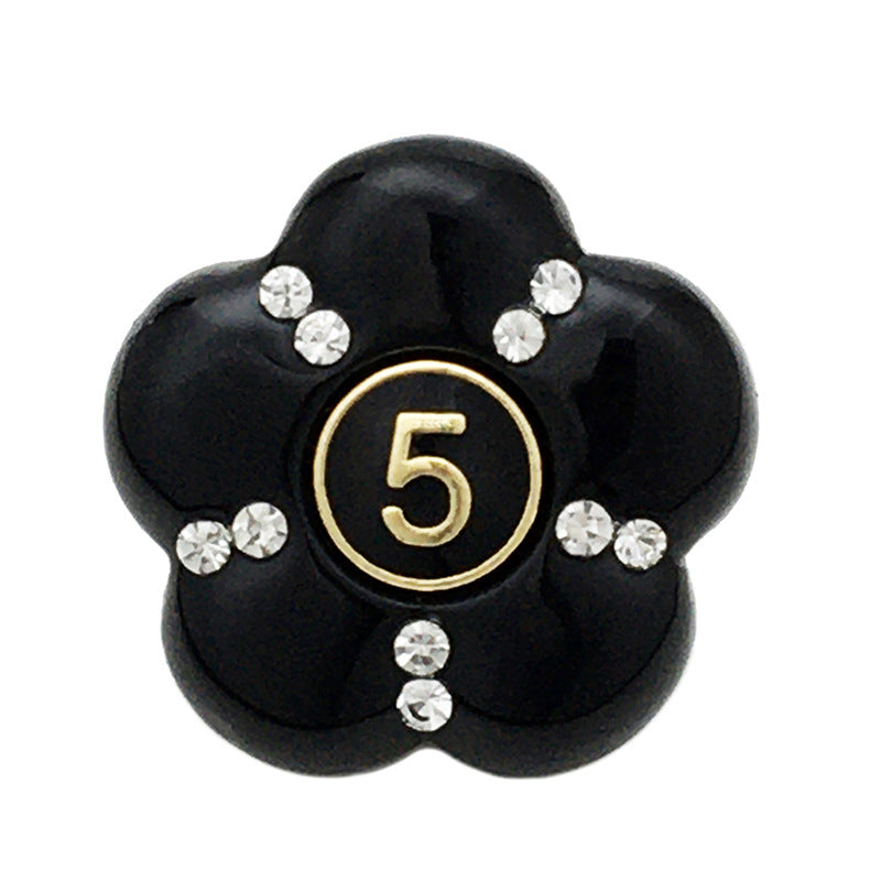 Black resin flower button with faceted rhinestones, number 5 in gold ring