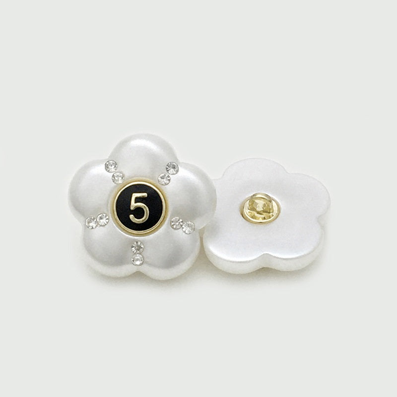 White resin flower button with number 5 and rhinestones; gold-tone back