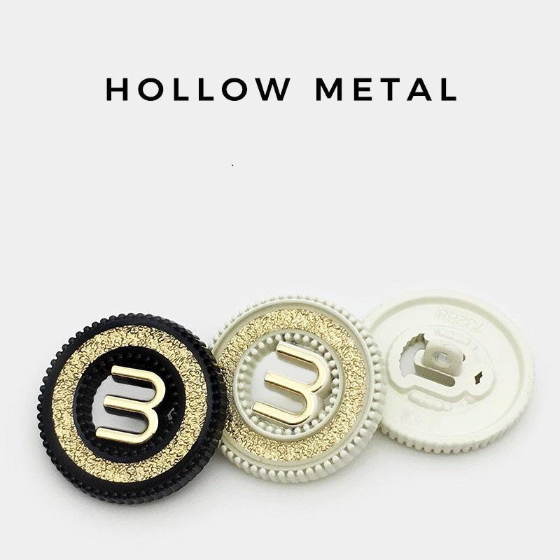 Black and ivory hollow metal buttons letter M with shank; one back view