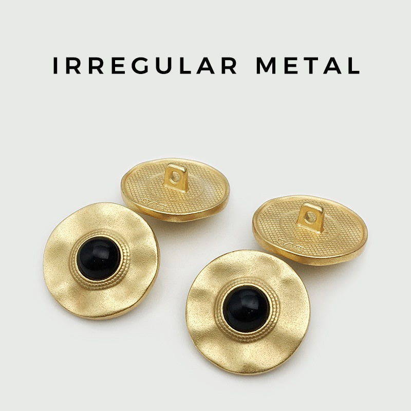 Irregular round gold buttons with black centers and rear loop openings