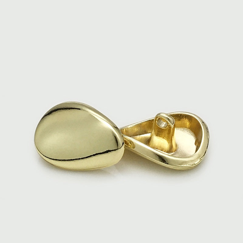 Gold irregular metal button with shank, domed front and visible loop stem