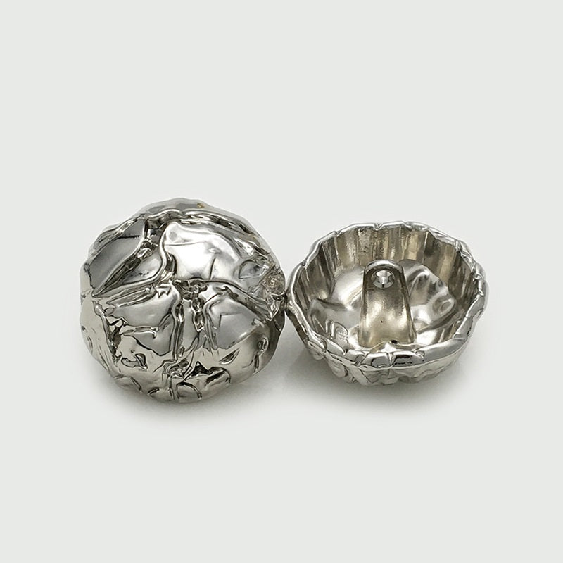 Silver mushroom pleated metal button pair: front with shank and underside view