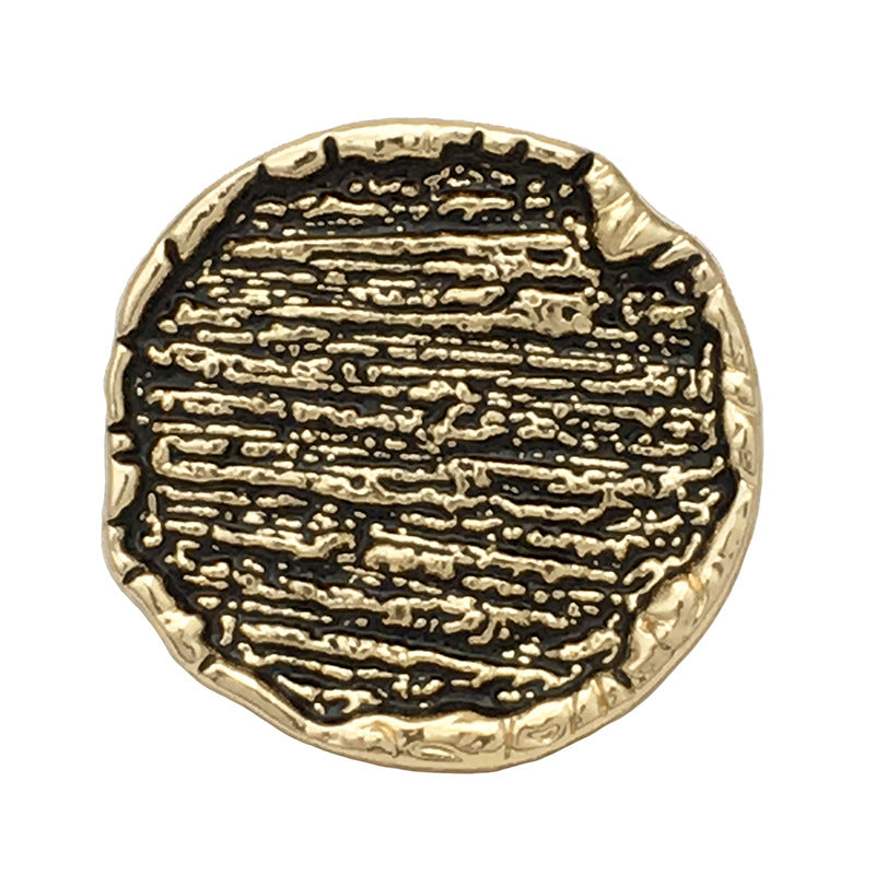 Irregular round metal sewing button, gold tone with black textured center