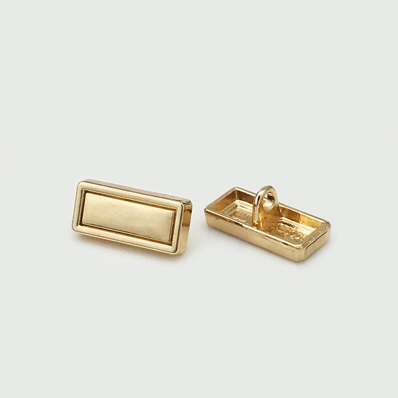Rectangular gold metal button with shank, front and back view