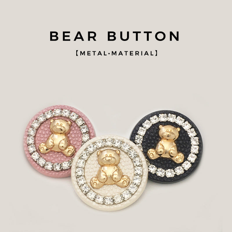 Round bear metal buttons in pink, ivory, and black, each with crystal-look border