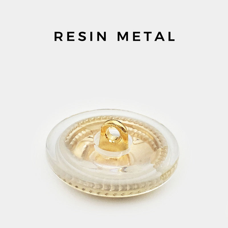 Back of 25mm round vintage cross button: clear resin disc with gold shank