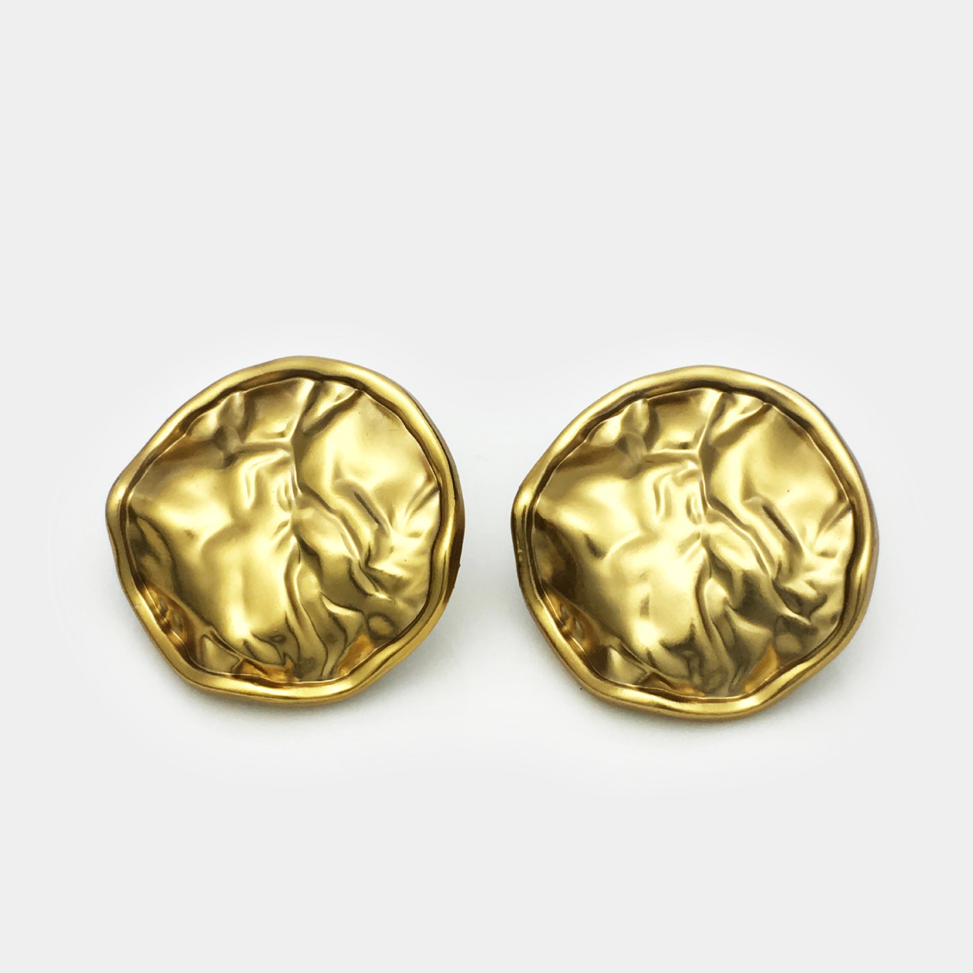Two antique gold pleated metal buttons, front view with scalloped rim texture