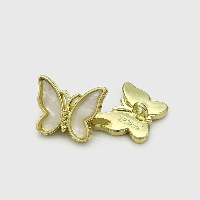 White 3D butterfly metal button, back view with gold-tone pin and clasp