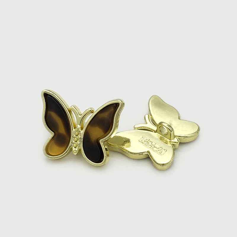 Brown 3D butterfly metal button with gold-tone frame and glossy shell center